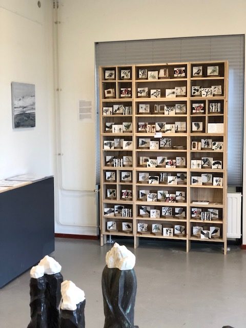 De kast met 100 verschillende porseleinen boekjes staat in Gallerie November Nes Ameland.